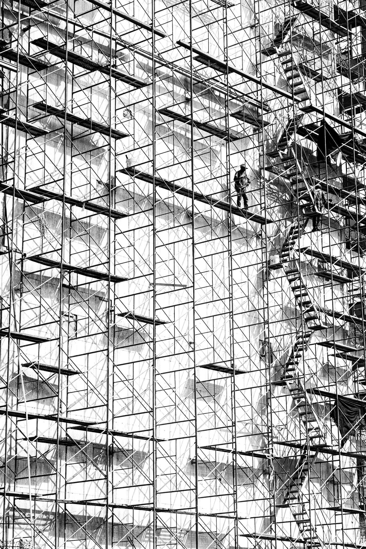 建物の外壁に沿って高く組まれた足場（サンプル写真）